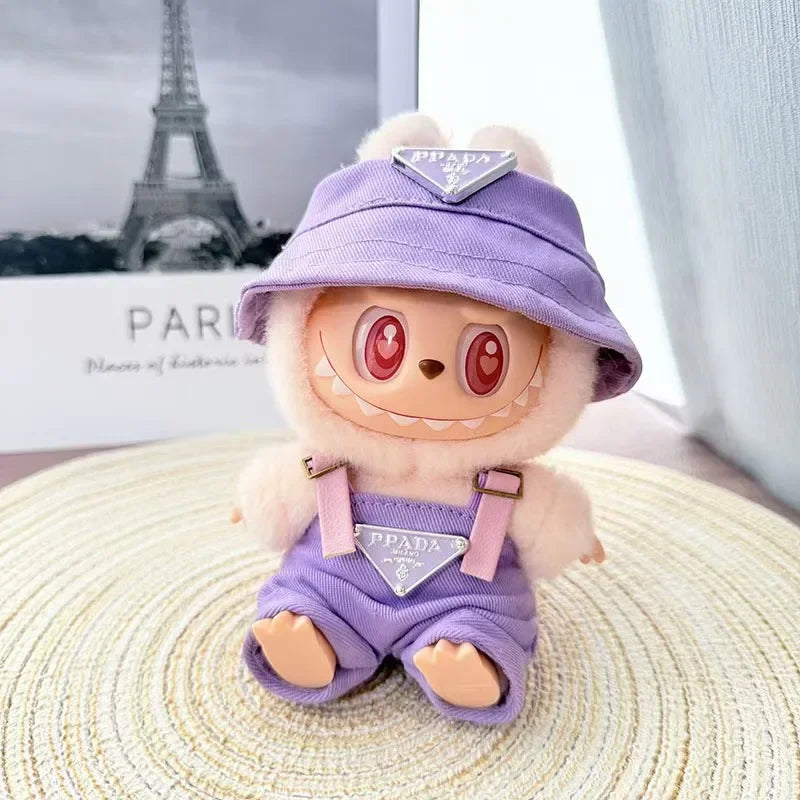 Labubu wearing a purple 'PPADA' fashion outfit with an overall, a shirt, and a bucket hat.