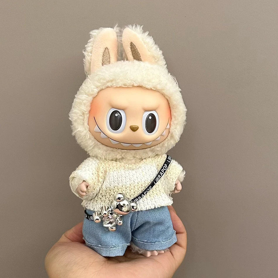 Labubu wearing a cozy streetwear outfit with a cream knitted sweater, denim shorts, and a crossbody bag.