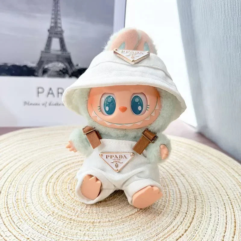Close-up of Labubu's overall with a 'PPADA' triangle logo and faux-leather suspenders.