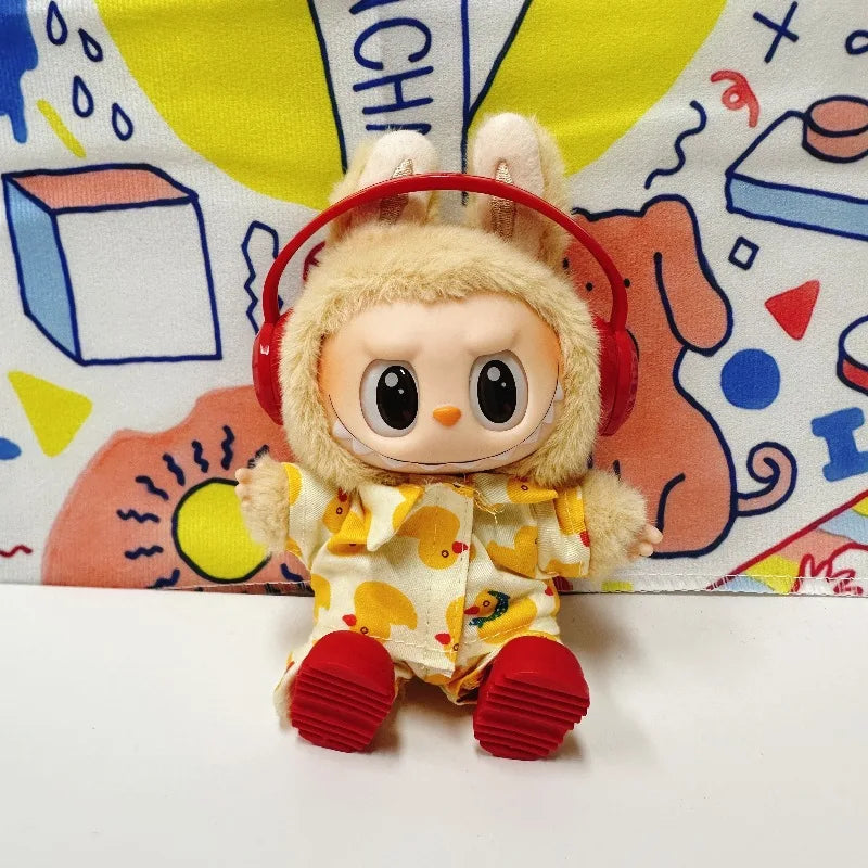 A 17cm Labubu figure wearing a yellow duck-print outfit and red shoes with headphones, posed in front of a colorful background (Labubu figure not included with the product).

