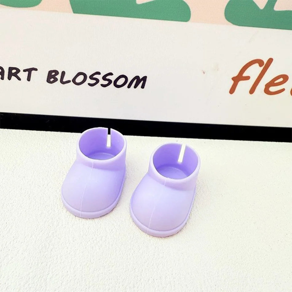 A pair of plain light purple miniature chunky boots for a Labubu figure, with a smooth texture and thick soles, sitting on a white surface.

